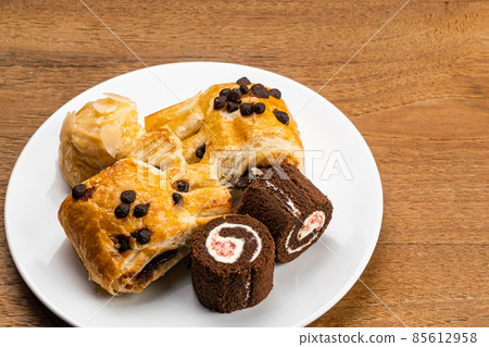 High angle view different kings of dessert in white ceramic dish.  85612958