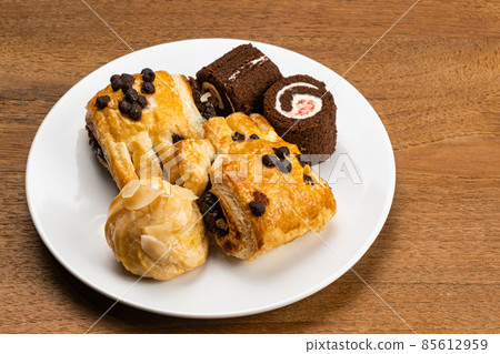 Various baked pastry dessert in white ceramic dish. Various baked pastry dessert in white ceramic dish. 85612959