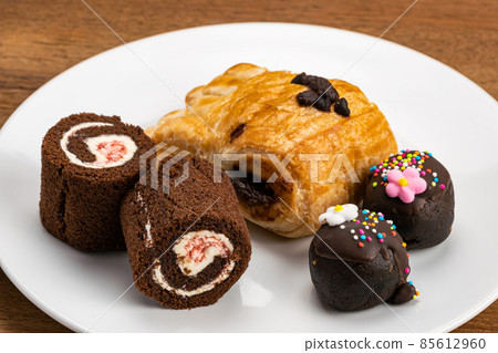 High angle view of various dessert in white ceramic dish. 85612960