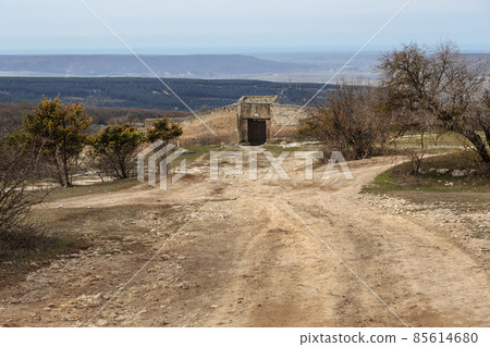 Eastern gate of Biyuk-Kapu and defensive wall of cave city Chufut-Kale. Bakhchysarai, Crimea Eastern gate of Biyuk-Kapu and defensive wall of cave city Chufut-Kale. Bakhchysarai, Crimea 85614680