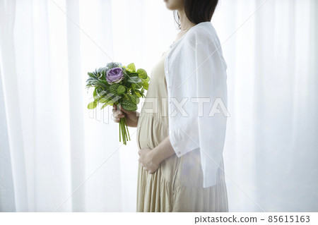 Pregnant woman with a bouquet 85615163