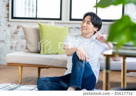 A middle-aged man relaxing in the living room 85617752