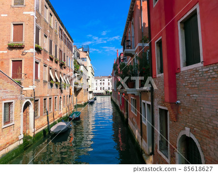 Classical picture of the venetian canals with boats across canal. Classical picture of the venetian canals with boats across canal. 85618627