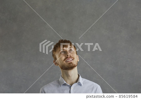 Headshot portrait of red-haired young hipster man freelancer or office worker looking up with dreaming expression on face. Daydreaming, future planning, wishing people emotion concept Headshot portrait of red-haired young hipster man freelancer or office worker looking up with dreaming expression on face. Daydreaming, future planning, wishing people emotion concept 85619584