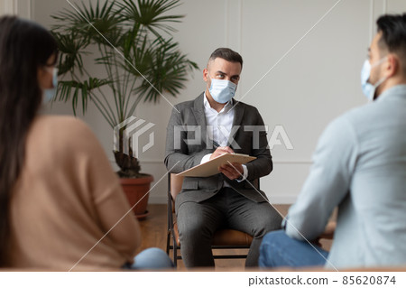 Couple having therapy session with therapist, psychologist writing and listening Couple having therapy session with therapist, psychologist writing and listening 85620874