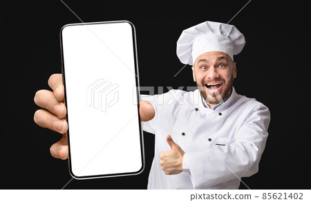Overjoyed professional chef showing phone with big empty screen and gesturing thumb up, mockup, closeup Overjoyed professional chef showing phone with big empty screen and gesturing thumb up, mockup, closeup 85621402
