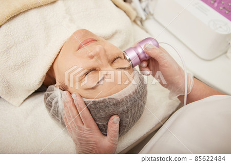 Lovely woman having anti-aging procedure in cosmetology clinic 85622484
