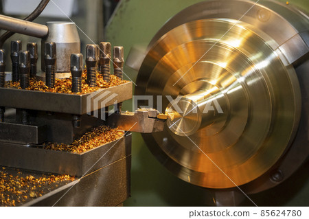 The lathe machine finishing cut the brass shaft parts by lathe tools. 85624780