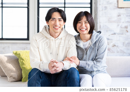 A young couple relaxing in the living room A young couple relaxing in the living room 85625178