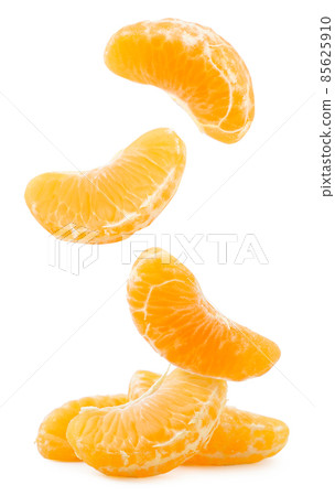 Tangerine slices fall on a heap on a white background. Isolated Tangerine slices fall on a heap on a white background. Isolated 85625910