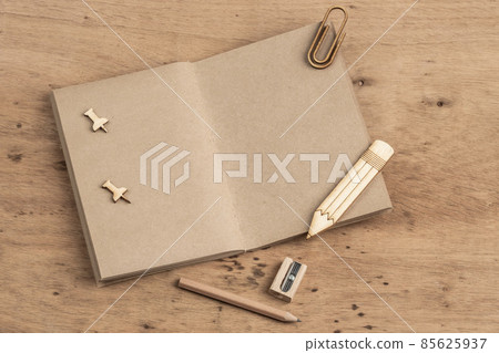 Blank notebook opened on a wooden table with copy space Blank notebook opened on a wooden table with copy space 85625937