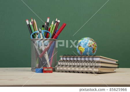 back to school template with stationeries and books on table over green back to school template with stationeries and books on table over green 85625966