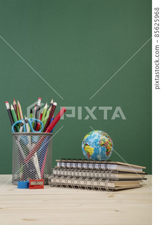 back to school template with stationeries and books on table over green back to school template with stationeries and books on table over green 85625968