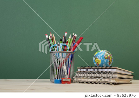 back to school template with stationeries and books on table over green back to school template with stationeries and books on table over green 85625970