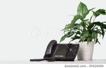 Computer monitor VOIP headset phone on desk at modern office. Telecommunications 85626089