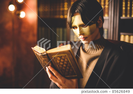 A man wearing a mask in his study 85626849