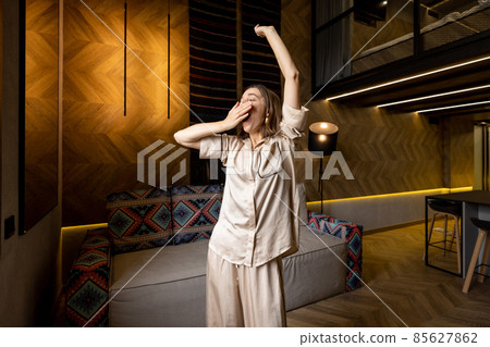 Woman waking at modern apartment Woman waking at modern apartment 85627862