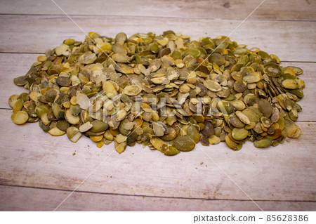 Pumpkin seeds on wooden background Pumpkin seeds on wooden background 85628386