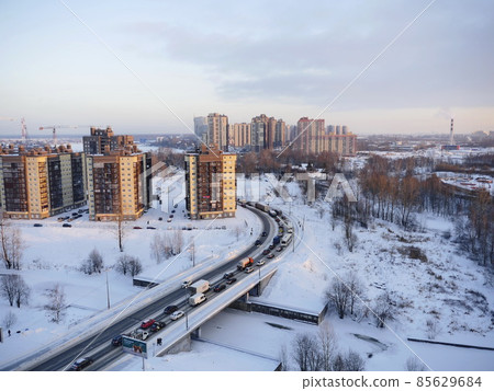 winter road to distant skyscrapers of a big city winter road to distant skyscrapers of a big city 85629684