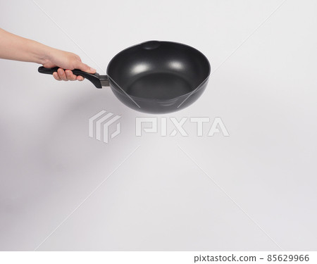Cleaning Electric non stick pan. Hand on white background cleaning the non stick pan with handy dish washing sponge which yellow color on the soft side and green on hard side for hygiene after cook. Cleaning Electric non stick pan. Hand on white background cleaning the non stick pan with handy dish washing sponge which yellow color on the soft side and green on hard side for hygiene after cook. 85629966