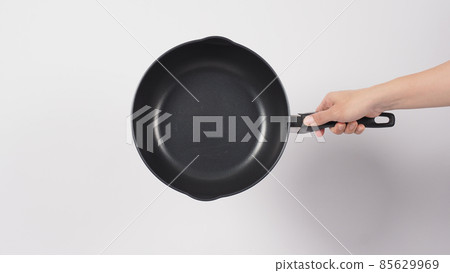 Cleaning Electric non stick pan. Hand on white background cleaning the non stick pan with handy dish washing sponge which yellow color on the soft side and green on hard side for hygiene after cook. Cleaning Electric non stick pan. Hand on white background cleaning the non stick pan with handy dish washing sponge which yellow color on the soft side and green on hard side for hygiene after cook. 85629969