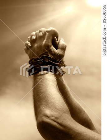 Chained hands praying for help 85630058