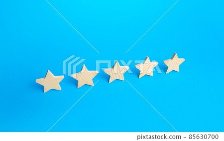 Five stars are in a row on a blue background. Rating evaluation concept. Popularity of restaurants, hotels or mobile applications. Service quality feedback. Great reputation. High satisfaction. 85630700