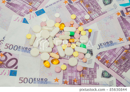Money and pills. Pills of different colors on money. medicine concept. Euro cash. The rise in the Money and pills. Pills of different colors on money. medicine concept. Euro cash. The rise in the 85630844