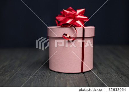 pink surprise gift box with red bow for birthday and happy valentine's day 85632064