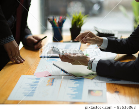 Male boss consulting with his financial worker. financial report on the table. Male boss consulting with his financial worker. financial report on the table. 85636868