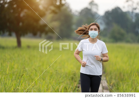 woman running in field with medical mask to protect Coronavirus(Covid-19) pandemic woman running in field with medical mask to protect Coronavirus(Covid-19) pandemic 85638991
