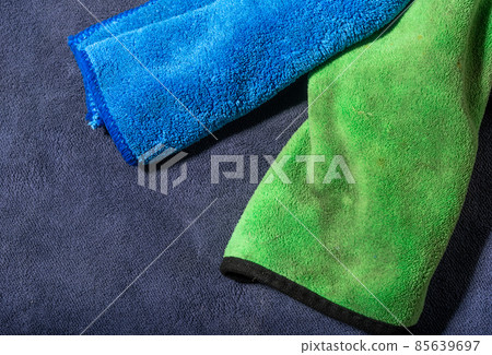 Microfiber ceiling cleaning and rubbing an hardwood floor with a microfiber cloth. 85639697