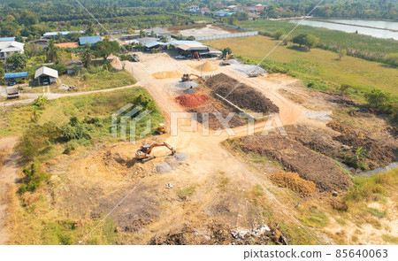 Aerial top view of dry ground rough cracks in the land with sand in factory industry for construction site. Arid pattern texture background. Aerial top view of dry ground rough cracks in the land with sand in factory industry for construction site. Arid pattern texture background. 85640063