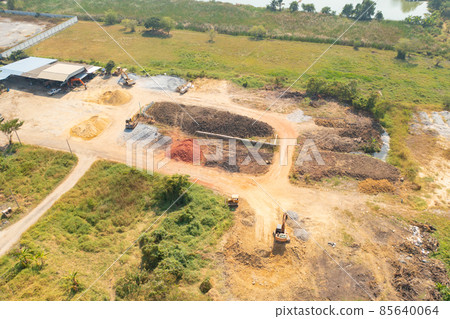 Aerial top view of dry ground rough cracks in the land with sand in factory industry for construction site. Arid pattern texture background. Aerial top view of dry ground rough cracks in the land with sand in factory industry for construction site. Arid pattern texture background. 85640064