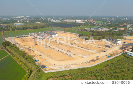 Aerial top view of dry ground rough cracks in the land with sand in factory industry for construction site. Arid pattern texture background. Aerial top view of dry ground rough cracks in the land with sand in factory industry for construction site. Arid pattern texture background. 85640066