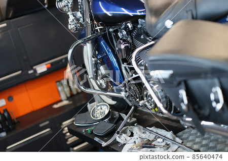Motorcycle and parts in the garage kitchen, blurry 85640474