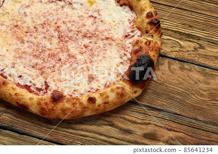 Pizza Margherita on wooden background, top view. Flyer and poster for Restaurants or pizzerias, template with delicious taste margarita pizza, mozzarella cheese Pizza Margherita on wooden background, top view. Flyer and poster for Restaurants or pizzerias, template with delicious taste margarita pizza, mozzarella cheese 85641234
