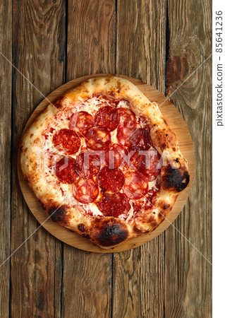 Pepperoni pizza on rustic, vintage style wood background. Top view Pepperoni pizza on rustic, vintage style wood background. Top view 85641236