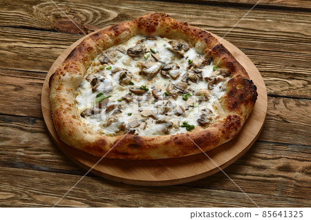 Delicious homemade pizza with mozzarella, mushrooms, beef and chicken. Wooden background, selective focus. Delicious homemade pizza with mozzarella, mushrooms, beef and chicken. Wooden background, selective focus. 85641325