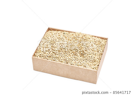 Small cardboard box with raw green lentils on a white background. Healthy food concept Small cardboard box with raw green lentils on a white background. Healthy food concept 85641717
