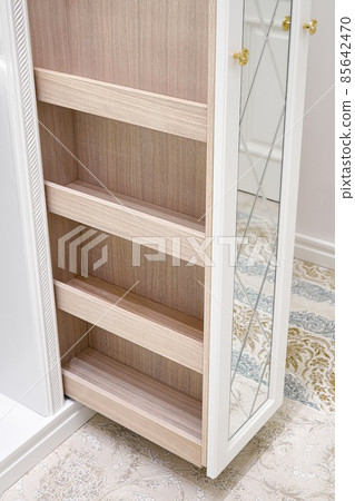 White walk-in closet with vertical slide out wooden cabinet White walk-in closet with vertical slide out wooden cabinet 85642470
