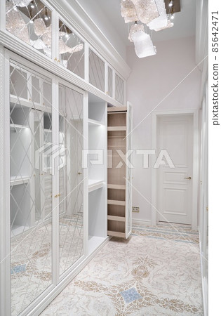 White walk-in closet with vertical slide out wooden cabinet White walk-in closet with vertical slide out wooden cabinet 85642471