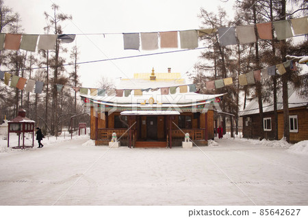 Buddhist temple Tibetan tradition in the snow. Buryatia, Siberia, Russia. Tourism on Lake Baikal Buddhist temple Tibetan tradition in the snow. Buryatia, Siberia, Russia. Tourism on Lake Baikal 85642627