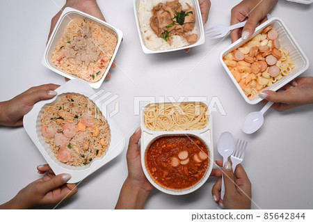 Overhead view of woman with frozen meal ready to microwave and eat. 85642844
