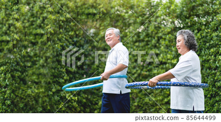 Asian Grandmother and Grandfather exercising with hula hoops 85644499