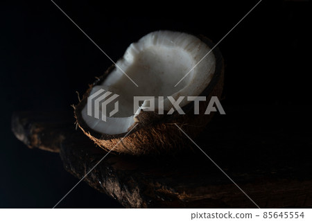 Chopped coconut on a wooden board close up 85645554