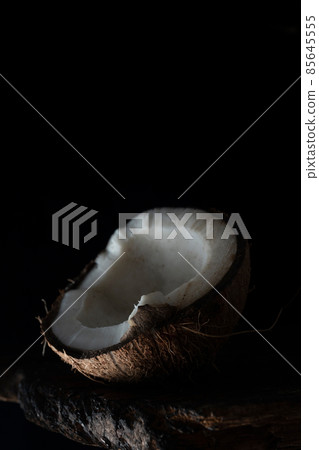 Chopped coconut on a wooden board close up Chopped coconut on a wooden board close up 85645555