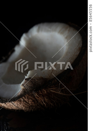 Chopped coconut on a wooden board close up Chopped coconut on a wooden board close up 85645556