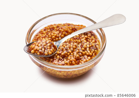 Classic Dijon mustard sauce in glass bowl isolated on white background Classic Dijon mustard sauce in glass bowl isolated on white background 85646006