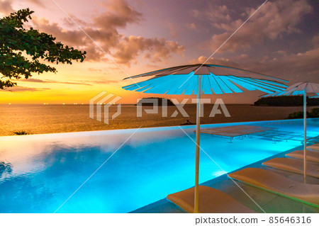 Sunset at the edge of a swimming pool at Kata beach in Phuket province, in Thailand 85646316